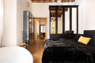 a bedroom with a bed and a mirror at Idyllia - Luxury home with terrace in Rome