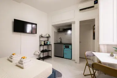 a living room with a table and a kitchen at Appartamento vicolo Savelli in Rome