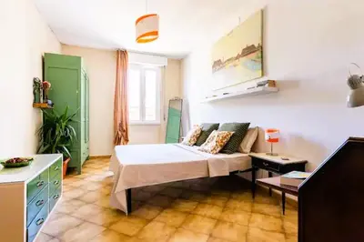 a room with a bed and a couch in it at Appartamento con balcone a San Giovanni, piano alto con vista su Roma in Rome