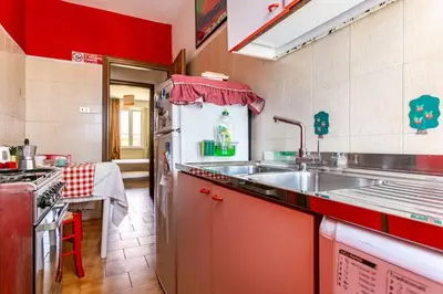 a kitchen with a sink and a stove at Appartamento con balcone a San Giovanni, piano alto con vista su Roma in Rome