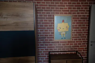 a wall with a picture of a robot on a brick wall at Casa Mercanti in Rome