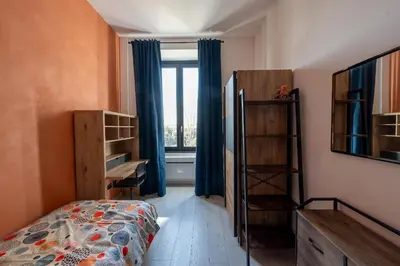 a small bedroom with a bed and a window at Casa Mercanti in Rome