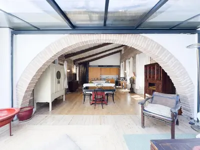an archway in a living room with a table and chairs at The Loft Boutique Apartment Vatican Museum in Rome