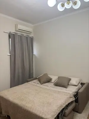 a bed in a white room with a window at JULIX - Roma Quadraro Apartment in Rome