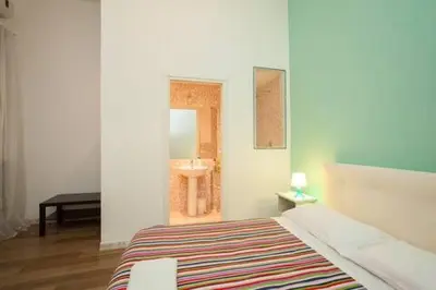 a bedroom with a bed and a sink in it at Large Apartment near Coliseum in Rome