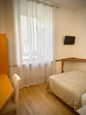 a bedroom with a bed and a large window at Green Hotel in Rome