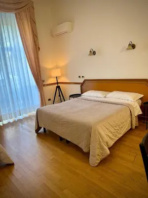 a bedroom with a large bed and a window at Green Hotel in Rome