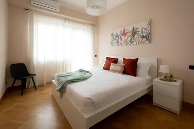 a bedroom with a white bed and a desk at Apartment near Vatican & Foro Italico - Rome in Rome