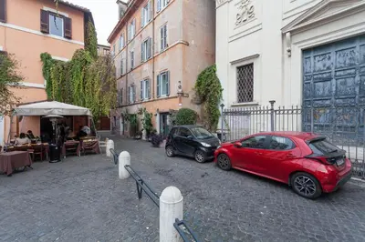 two cars parked on a street next to a building at Il Piccolo Arco in Rome