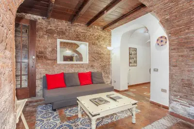 a living room with a couch and a table at Il Piccolo Arco in Rome