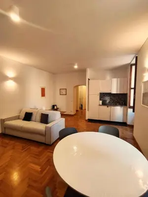 a living room with a white couch and a table at Residenza Coronari in Rome