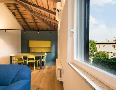 a kitchen and dining room with a table and a window at La Garbatella dei Cesaroni in Rome