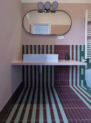 a bathroom with a sink and a mirror at La Garbatella dei Cesaroni in Rome