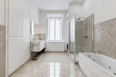 a white bathroom with a tub and a sink at FaMa - Mecenate 3BR & 2BA in Rome