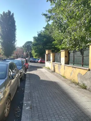 a parking lot with cars parked on the side of a street at Holiday Home Roma in Rome