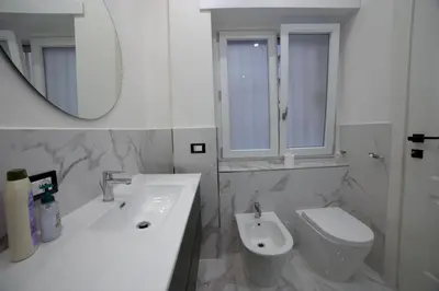 a bedroom with a bed and a television in it at Suites Conca D'Oro, Roma in Rome