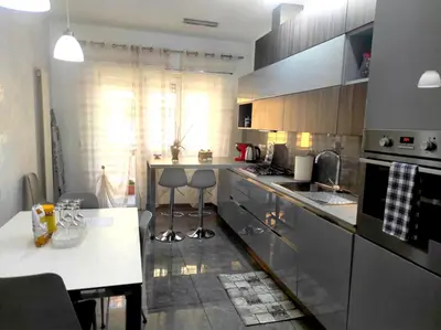 a kitchen with stainless steel appliances and a counter top at Dolce Roma House - Parco Appia Antica , Netflix, Prime e Metro sotto casa in Rome
