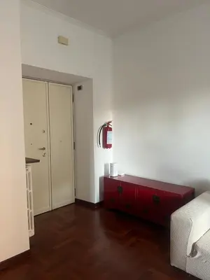 a room with a red dresser and a red bed in it at Incontro tra Oriente e Occidente in Rome