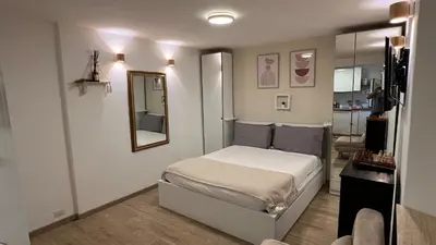 a small bedroom with a bed and a mirror at Elegant Studio at Vatican Museum in Rome
