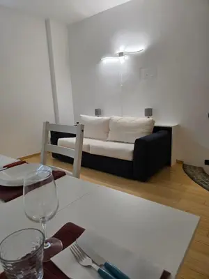 a living room with a couch with a table with a wine glass at San Pietro Station 2 in Rome