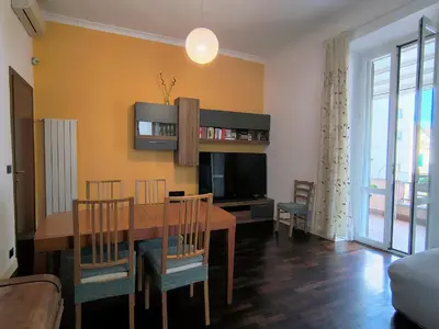 a living room with a dining table and a television at Domus Oleandri - WelcomeToRhome in Rome