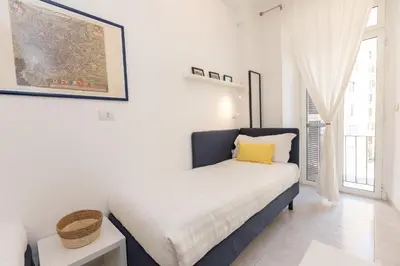 a bedroom with a bed and a large window at Vatican Museum Family Apartment in Rome