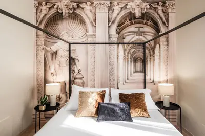 a bedroom with a white bed with a fancy ceiling at 4 bedrooms, luxury 5 minutes from the Colosseum Jacuzzi in Rome