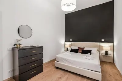 a bedroom with a large bed with a black headboard at 4 bedrooms, luxury 5 minutes from the Colosseum Jacuzzi in Rome