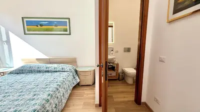 a small bedroom with a bed and a toilet at Il Segreto del Borgo Vaticano in Rome