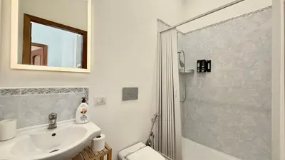 a bathroom with a sink and a shower at Il Segreto del Borgo Vaticano in Rome