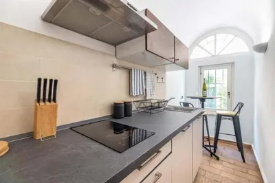 a kitchen with a black counter top in a room at Velantia Fori Apartment in Rome
