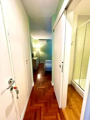 a hallway with a door to a room with wood floors at Calisto 6 in Rome