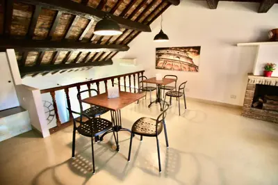 a dining room with tables and chairs and a fireplace at Calisto 6 in Rome