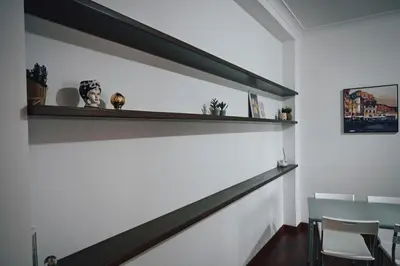 a dining room with a shelf on the wall at Room in Rome in Rome