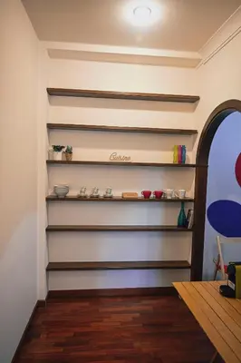a wall with shelves in a room at Room in Rome in Rome