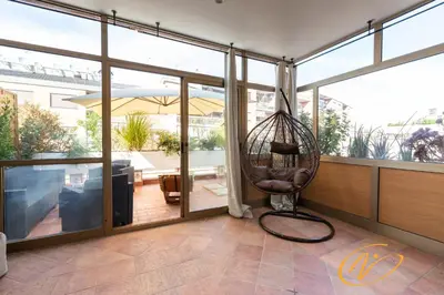 a room with a hanging chair and a balcony at Nuccia Luxury Apartment and Suites - Terrace, bright glass lounge, 200mt to Metro-5min to Vatican, A-C in Rome
