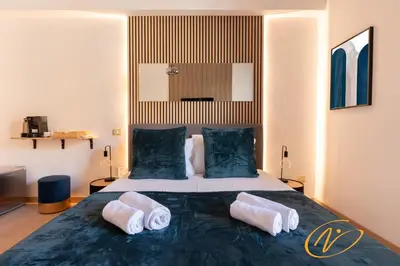 a bedroom with a bed with two pillows on it at Nuccia Luxury Apartment and Suites - Terrace, bright glass lounge, 200mt to Metro-5min to Vatican, A-C in Rome