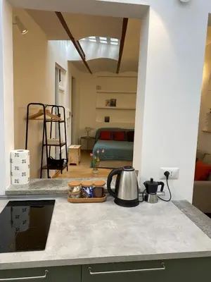 a kitchen counter with a tea kettle and a bedroom at Navona Sweet Home in Rome
