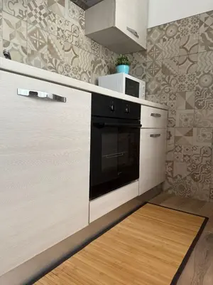a kitchen with a stove and a microwave at Interno 2 alle Mura in Rome