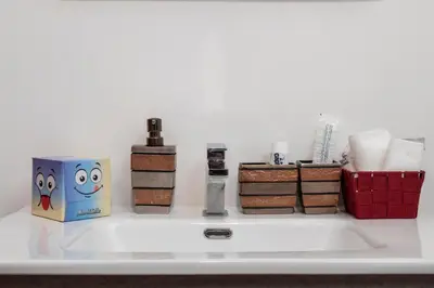 a shelf with towels and toiletries on it at Piazza Vittorio Urban Stay in Rome