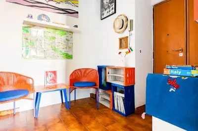 a room with two desks and a table and chairs at Ampia stanza luminosa a San Giovanni, piano alto con finestra o balcone in Rome