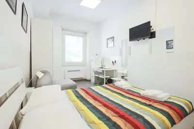 a bedroom with a bed and a desk and a chair at San Giovanni rooms in Rome