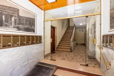 a hallway of a building with stairs and a painting at NOSTROMONDO-Playful & Modern Apartment in the heart of Pigneto in Rome