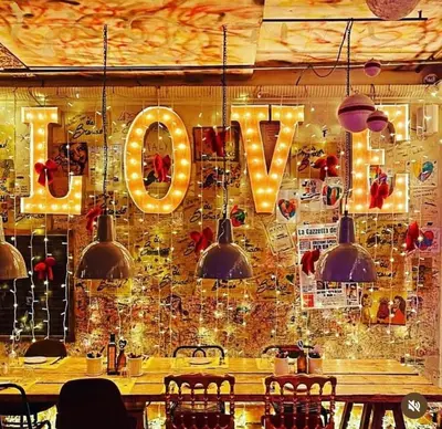 a restaurant with a table and a v sign on the wall at Da Brando Loft PONTE MILVIO in Rome