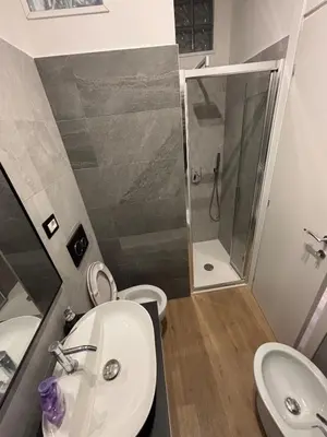 a bathroom with a toilet and a sink and a shower at Imera House City Retreat in Rome