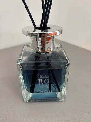a glass bottle with some sticks in it at Imera House City Retreat in Rome