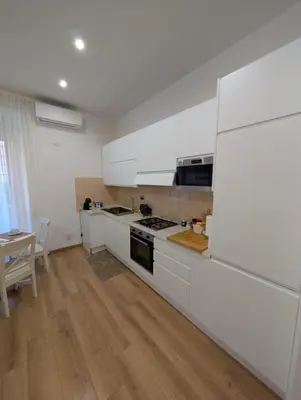 a hallway of a house with a book shelf at Vatican Family Apartment in Rome