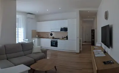 a bedroom with a bed and a desk and a mirror at Vatican Family Apartment in Rome