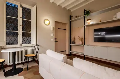a living room with a couch and a tv at Monti Charme in Rome