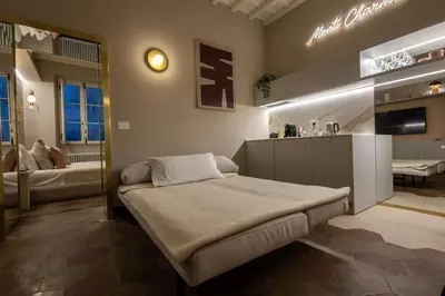 a room with a bed in the middle of a room at Monti Charme in Rome